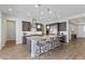 Modern kitchen featuring a large island with granite countertops, stainless appliances, and dark wood cabinets at 3025 Merlesco Ave, Henderson, NV 89044