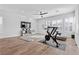 Bright workout area with a treadmill, exercise bike, and entertainment center by windows at 3025 Merlesco Ave, Henderson, NV 89044