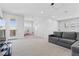 Upstairs loft with gray sectional sofa, and a sliding door to the outdoor balcony at 3025 Merlesco Ave, Henderson, NV 89044