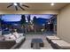 Relaxing covered patio area with seamless flow to a twilight backyard playground and kitchen at 3025 Merlesco Ave, Henderson, NV 89044