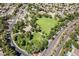 Lovely aerial shot featuring a neighborhood park with lush green space, tennis courts, and mature trees at 306 Treehouse Ct, Henderson, NV 89012