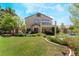 Home featuring a backyard, second story balcony, a shed and mature trees at 306 Treehouse Ct, Henderson, NV 89012