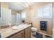 Bathroom with a shower, toilet, framed mirror, vanity and shuttered window at 306 Treehouse Ct, Henderson, NV 89012