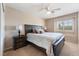 Comfortable bedroom featuring a ceiling fan, window with shutters and a large bed at 306 Treehouse Ct, Henderson, NV 89012