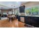 Open kitchen with dark cabinets, stainless steel appliances, and wood flooring, perfect for Gathering gatherings at 306 Treehouse Ct, Henderson, NV 89012