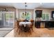 Cozy breakfast nook with a table for four and a view of the backyard through sliding glass doors at 306 Treehouse Ct, Henderson, NV 89012