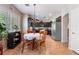 Bright breakfast nook featuring a rustic chandelier, wood flooring and cabinets, and backyard views at 306 Treehouse Ct, Henderson, NV 89012