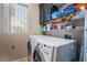 Well-organized laundry room with modern washer and dryer at 306 Treehouse Ct, Henderson, NV 89012