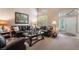 Comfortable living room with vaulted ceiling, shutters, plush leather seating, and bright natural light at 306 Treehouse Ct, Henderson, NV 89012