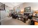 Elegant living room featuring plush leather seating, a chandelier, and a view into the dining room at 306 Treehouse Ct, Henderson, NV 89012