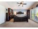 Spacious main bedroom featuring vaulted ceiling, wall-mounted bookcase, and dark wood furnishings at 306 Treehouse Ct, Henderson, NV 89012