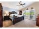 Spacious main bedroom featuring vaulted ceiling, sliding doors to balcony, and dark wood furnishings at 306 Treehouse Ct, Henderson, NV 89012