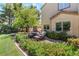 Inviting patio with comfortable seating and vibrant flowerbeds around the edge of the hardscape at 306 Treehouse Ct, Henderson, NV 89012