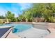 Gorgeous pool and spa with a waterfall feature surrounded by lush landscaping at 306 Treehouse Ct, Henderson, NV 89012