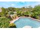 Inviting pool with lush landscaping and a privacy fence at 306 Treehouse Ct, Henderson, NV 89012