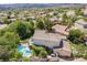 Back of house featuring sparkling pool and spa, deck, tile roof, and desert landscaping at 306 Treehouse Ct, Henderson, NV 89012