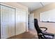 View of an empty office or bedroom with a sliding door closet and chair at 306 Treehouse Ct, Henderson, NV 89012