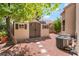 Backyard shed with double doors, next to the home's AC units at 306 Treehouse Ct, Henderson, NV 89012