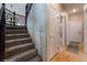 Carpeted staircase with decorative iron railing leading to the upper level at 306 Treehouse Ct, Henderson, NV 89012