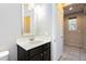 Half bathroom featuring a single sink vanity, a white countertop and a decorative framed mirror at 3163 Biccari Ave, Henderson, NV 89044