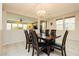 Charming dining room with stylish chandelier, wood table, seating for six, and a view to the living area at 3163 Biccari Ave, Henderson, NV 89044