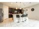 Modern kitchen featuring a large center island, stylish pendant lighting, and stainless steel appliances at 3163 Biccari Ave, Henderson, NV 89044