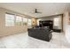 Bright living room with large windows, tile floors, and a ceiling fan for a comfortable and inviting space at 3163 Biccari Ave, Henderson, NV 89044