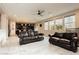 Open-concept living room with hardwood floors, large windows, and seamless flow into the kitchen and dining area at 3163 Biccari Ave, Henderson, NV 89044