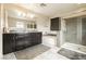 Elegant main bathroom featuring double sinks, a soaking tub, and a glass-enclosed shower at 3163 Biccari Ave, Henderson, NV 89044