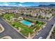 Expansive aerial shot showcasing the community pool, playground, and surrounding homes with mountain views at 387 Layla Bay St, Henderson, NV 89014