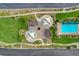 Overhead shot featuring a community park with playground and pool, framed by manicured lawns and walking paths at 387 Layla Bay St, Henderson, NV 89014