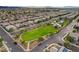 Gorgeous aerial view of neighborhood featuring landscaped park, swimming pool, and resident homes at 387 Layla Bay St, Henderson, NV 89014