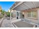 Inviting back patio featuring a cozy fire pit, heater, and shaded pergola, perfect for outdoor entertaining at 387 Layla Bay St, Henderson, NV 89014