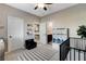 Neutral Bedroom features a black crib, area rug, chair, and shelving for books and baby items at 387 Layla Bay St, Henderson, NV 89014