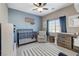 Cozy Bedroom with a crib, changing table, and soft blue accent wall at 387 Layla Bay St, Henderson, NV 89014