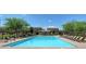 Beautiful community swimming pool with lounge chairs, surrounded by a secure fence at 387 Layla Bay St, Henderson, NV 89014