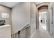 Upstairs hallway with carpet, railing with gate, window, and views into bedrooms at 387 Layla Bay St, Henderson, NV 89014