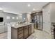 Open-concept kitchen with a granite island, stainless steel appliances, and a view of the living area at 387 Layla Bay St, Henderson, NV 89014