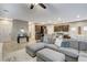 Open floor plan with living room featuring a large sectional sofa flowing into the kitchen at 387 Layla Bay St, Henderson, NV 89014