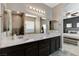 Bright main bathroom featuring a large vanity with dual sinks, modern fixtures, and a view to the main bedroom at 387 Layla Bay St, Henderson, NV 89014