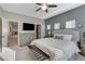 Comfortable main bedroom featuring a ceiling fan, neutral decor, and a convenient door to the bathroom and walk-in closet at 387 Layla Bay St, Henderson, NV 89014