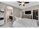 Comfortable main bedroom with ceiling fan, carpet floors, a dresser with TV, and access to the walk-in closet and main bathroom at 387 Layla Bay St, Henderson, NV 89014