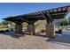 Neighborhood picnic tables under a covered pergola with stone pillars and brick flooring at 387 Layla Bay St, Henderson, NV 89014