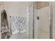 Modern shower featuring white tile, glass doors, and updated hardware at 387 Layla Bay St, Henderson, NV 89014