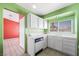 Functional kitchen with white countertops and cabinets, tile flooring, and bright green walls at 3910 Cheryl Clay Way, North Las Vegas, NV 89032