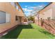 View of backyard featuring artificial turf, patio, and outdoor kitchen at 4133 Perfect Lure St, Las Vegas, NV 89129