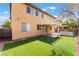 A view of the backyard with artificial turf and covered patio at 4133 Perfect Lure St, Las Vegas, NV 89129