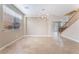 Open living room with recessed lighting, stone floors, neutral paint, modern light fixture and staircase at 4133 Perfect Lure St, Las Vegas, NV 89129