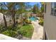 Backyard with a pool and lush tropical landscaping at 4200 Topsider St, Las Vegas, NV 89129