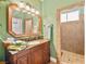 Bathroom features a single sink vanity, large mirror and tiled walk-in shower at 4200 Topsider St, Las Vegas, NV 89129